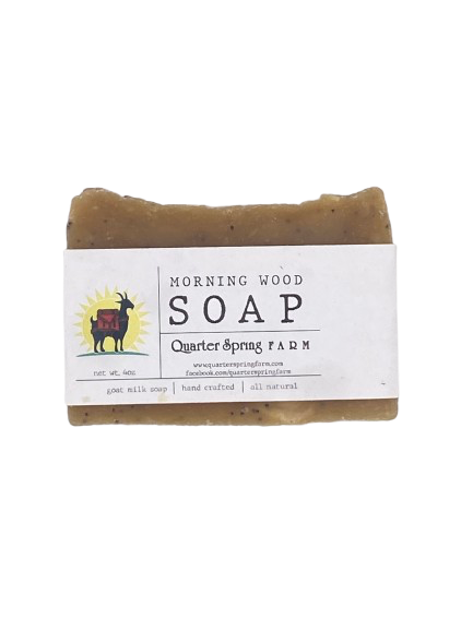 Bar of soap with a label on a white background soap is called Morning Wood, made with cinnamon essential ol