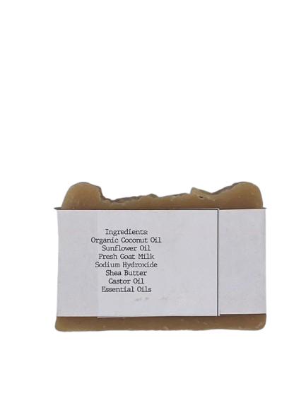Goat milk soap bar wrapped in white belly band labeled ‘Summer Nights’ with lavender, orange, and patchouli essential oils