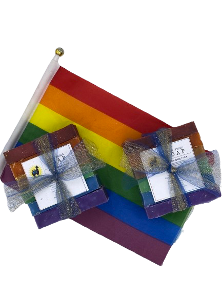 Set of rainbow-themed soap packages with visible branding on a white background