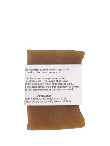 Solid dishwashing soap block wrapped in white belly band labeled ‘Dishwashing Block’ with 4 Thieves essential oils And ingredients list