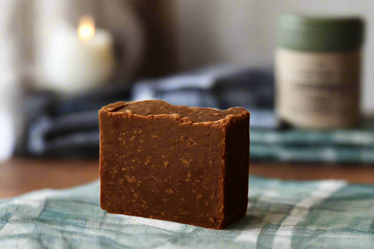 Brown handmade bar soap with grandpa’s flannel shirt in background
