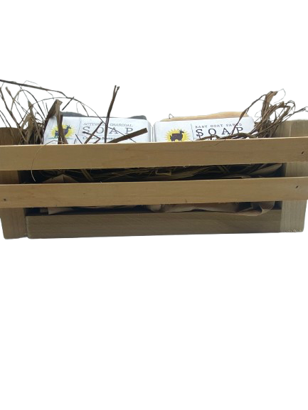 Four bars of soap in a wooden basket with natural elements on a white background