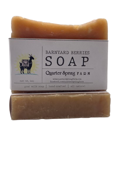 Bar of soap with a label for Barnyard Berries Soap from Quarter Spring Farm on a white background