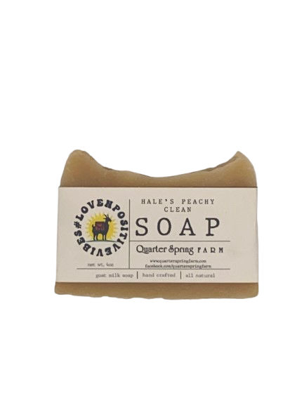 Goat milk soap bar wrapped in white belly band labeled Hale’s Peachy Clean