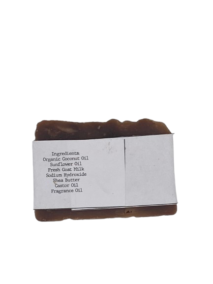 Goat milk soap bar wrapped in white belly band labeled ‘Pappy’s Flannel Shirt’ with warm mahogany, bergamot, and musk scent And ingredients list